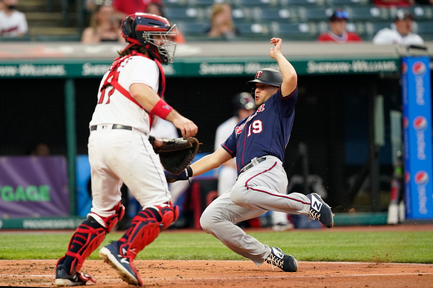 Alex Kirilloff scores as Cleveland catcher Austin Hedges waits for the ball in the fourth inning