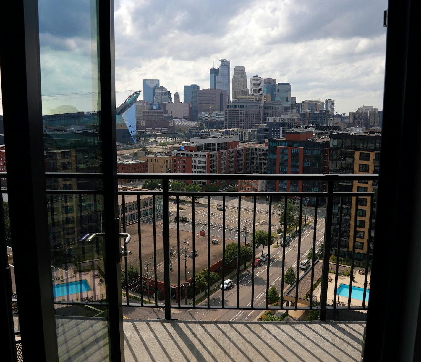 The view of downtown Minneapolis from the Ross' condo. ] ANTHONY SOUFFLE • anthony.souffle@startribune.com Gail and Randy Ross sat for a portrait in their condo on the 14th floor of The Legacy Minneapolis Friday, Aug. 14, 2020 in downtown Minneapolis. The COVID-19 pandemic has changed life downtown with theaters closed, office buildings empty and restaurants doing social distancing.