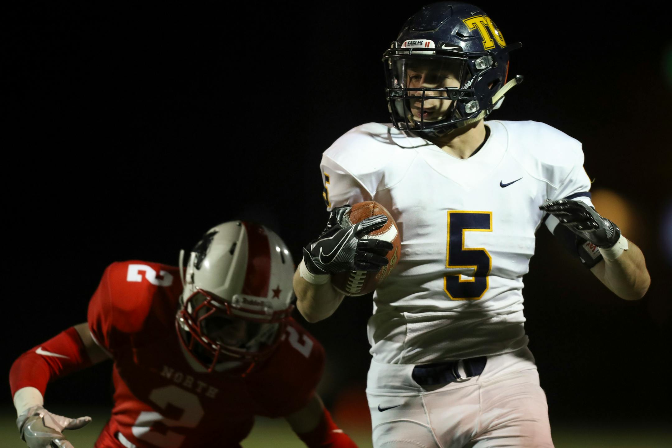 Totino-Grace's Ivan Burlak eluded Lakeville North's Nick Gregg after catching a pass for a 54 yard touchdown reception in the state quarterfinals.