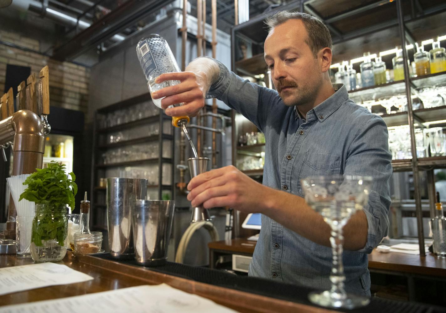 Mark Jenson mixed a Brighton Peach mixed drink for a customer on Thursday afternoon at Vikre Distillery.]
ALEX KORMANN &#x2022; alex.kormann@startribune.com A tour of breweries and distilleries in Duluth, MN including Canal Park Brewery and Vikre Distillery, photographed on Thursday September 5, 2019.