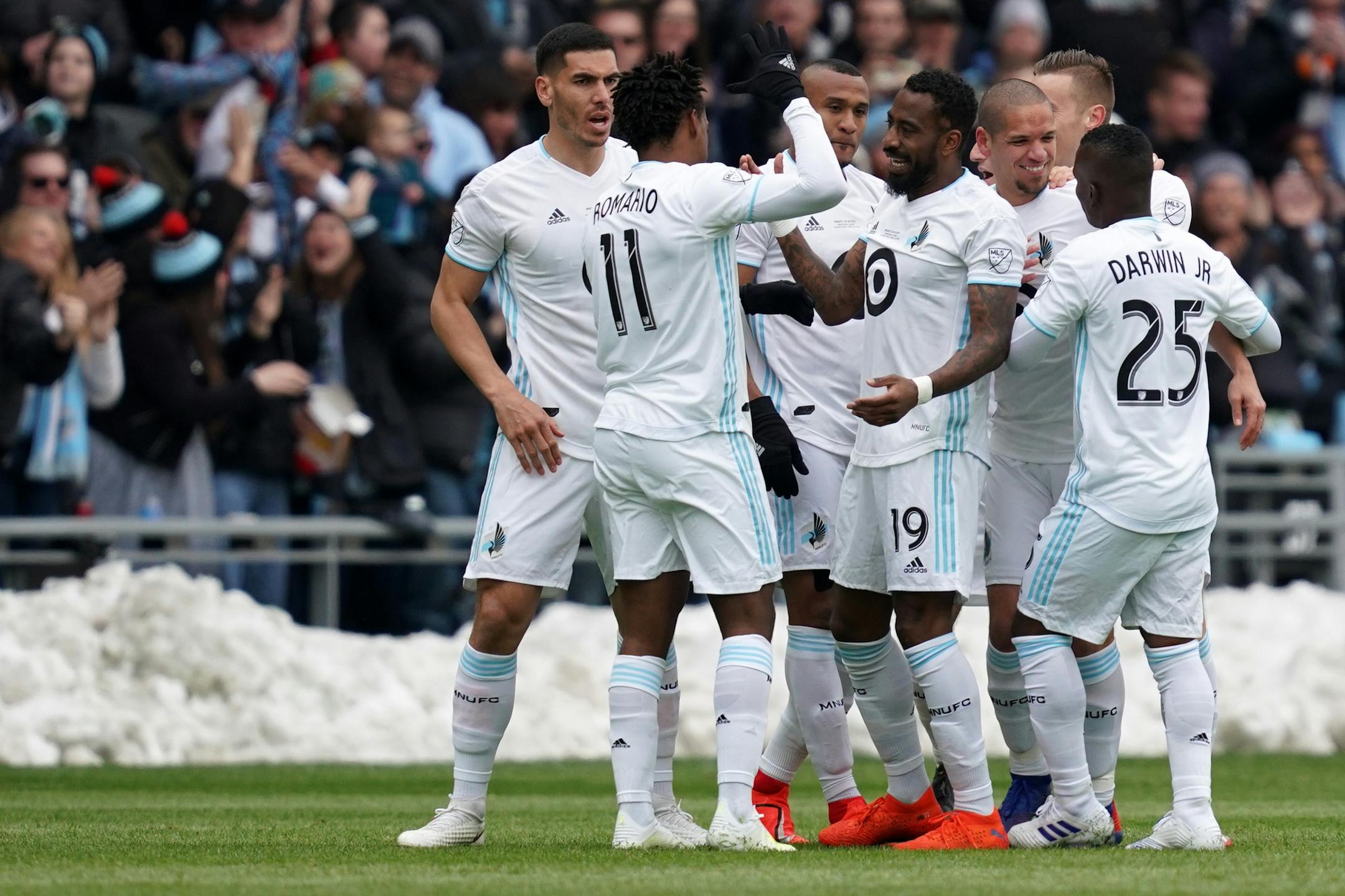 Minnesota United midfielder Osvaldo Alonso (6) was mobbed by his teammates after scoring the first Loon goal at Allianz Field in the first half.