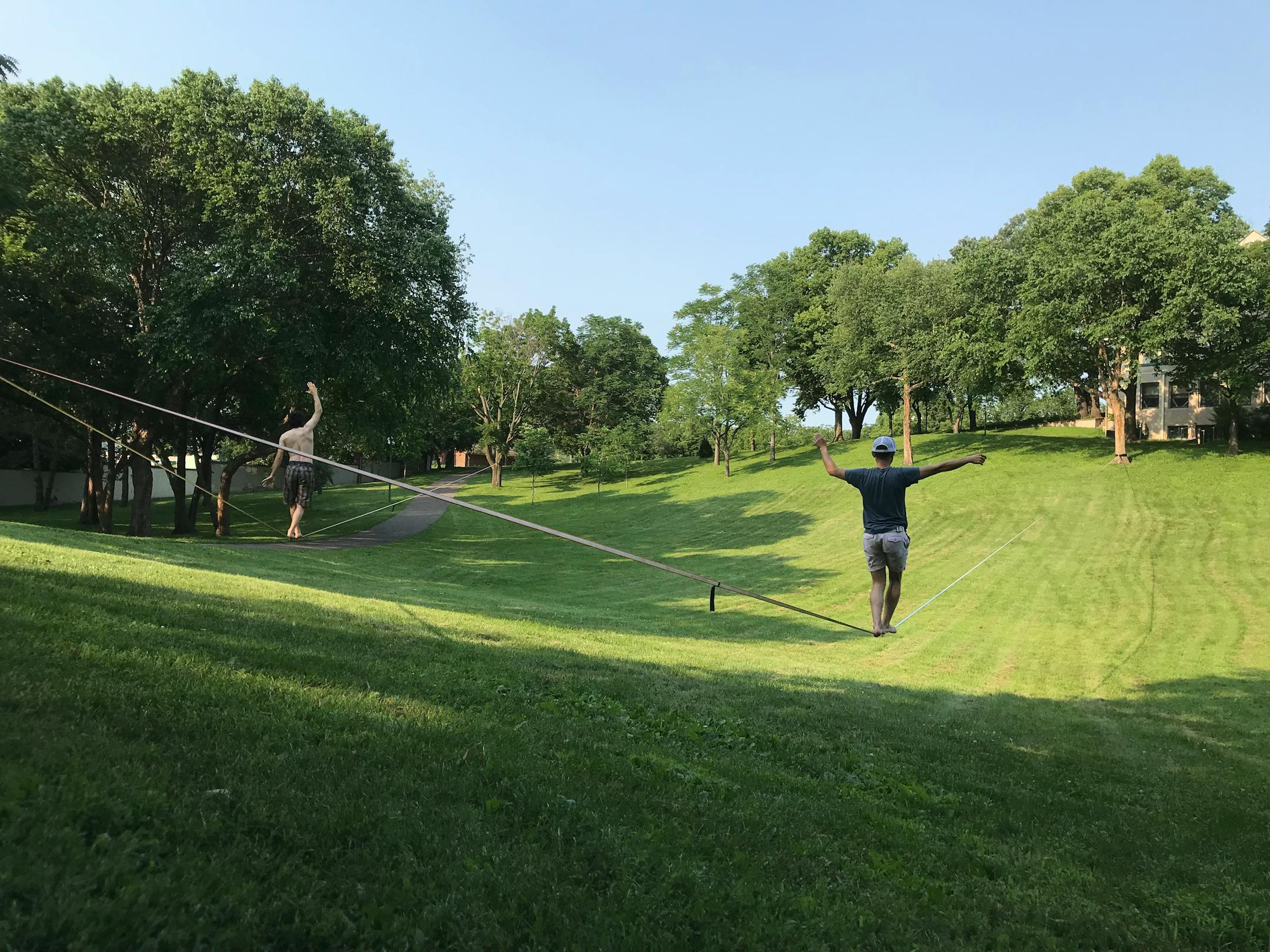 Ilya Begelman and Aaron Decker on slacklines at Lyndale Farmstead Park.