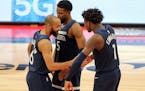 Minnesota Timberwolves' Jordan McLaughlin (6) is congratulated by teammates Malik Beasley (5) and Anthony Edwards after his late free throws during th