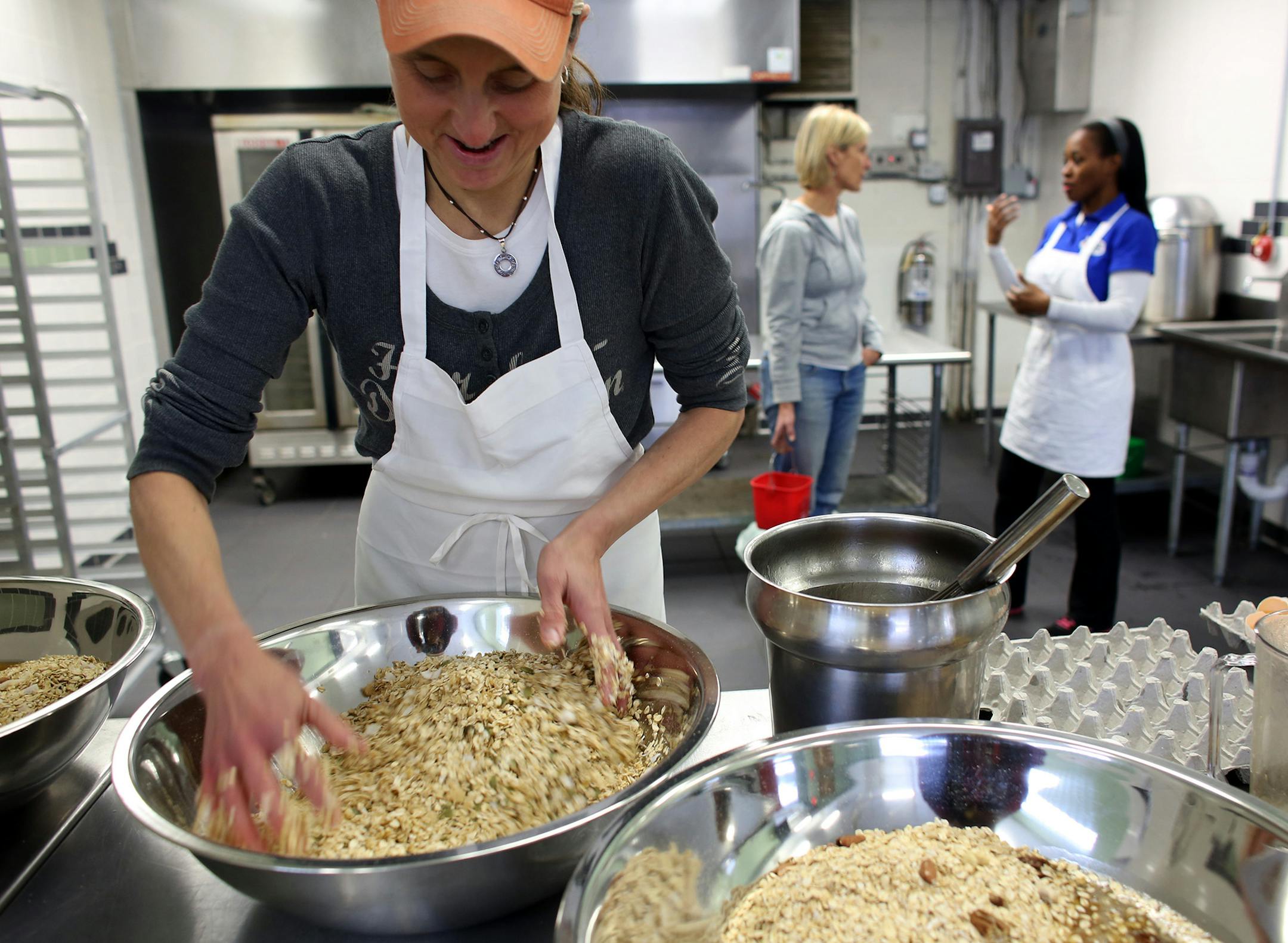 Angela Gustafson, of Gustola Granola, mixed her granola by hand. ] (KYNDELL HARKNESS/STAR TRIBUNE) kyndell.harkness@startribune.com At City Food Studio in Minneapolis, Min., Tuesday, December 9, 2014.