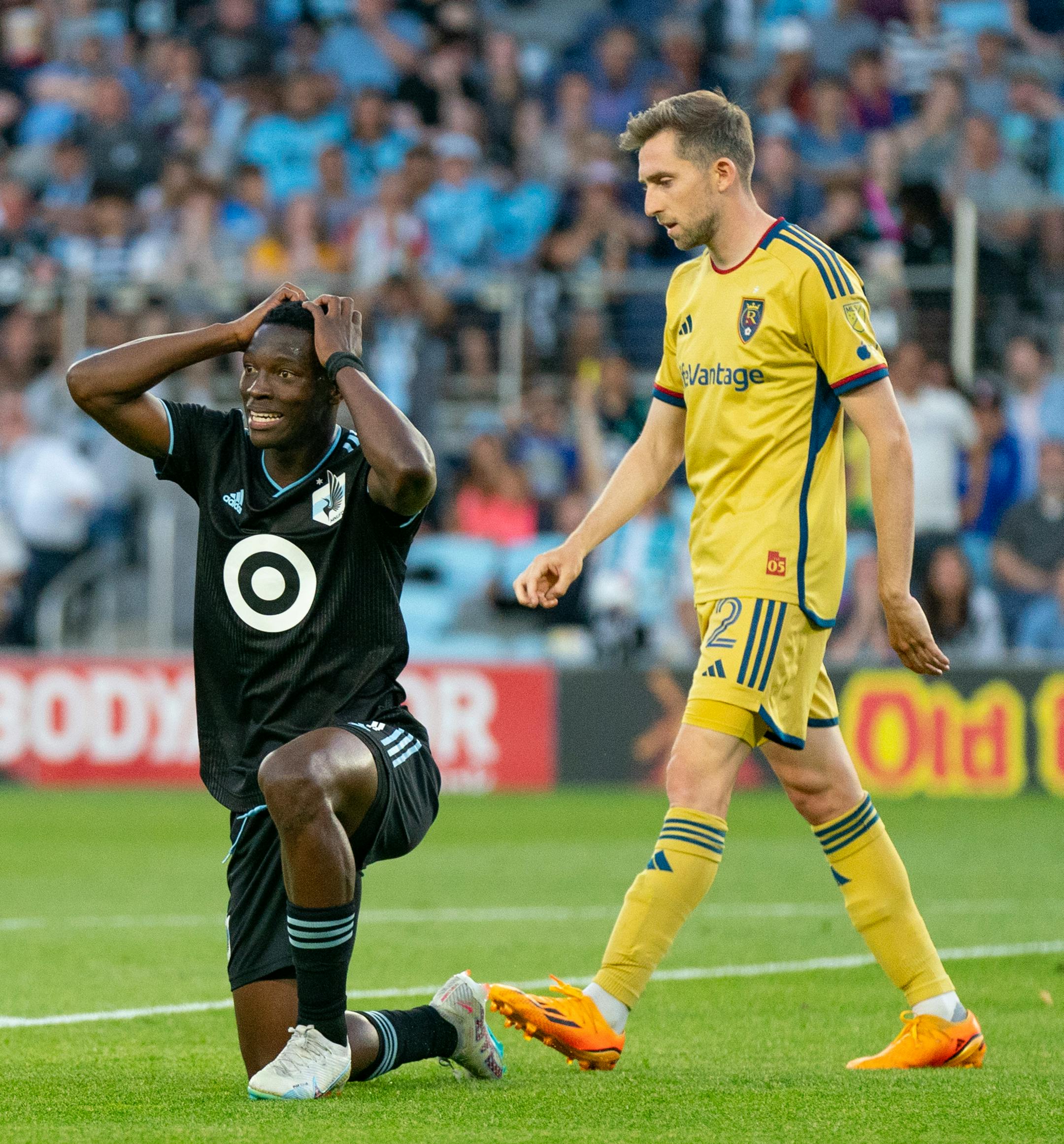 Minnesota United forward Bongokuhle Hlongwane (21) reacts in front of Real Salt Lake defender Andrew Brody (2) after his team narrowly missed a shot attempt.
