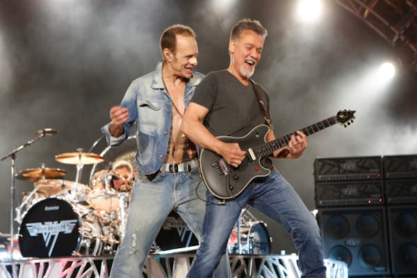 Eddie Van Halen, right, performs with David Lee Roth during a Van Halen concert.