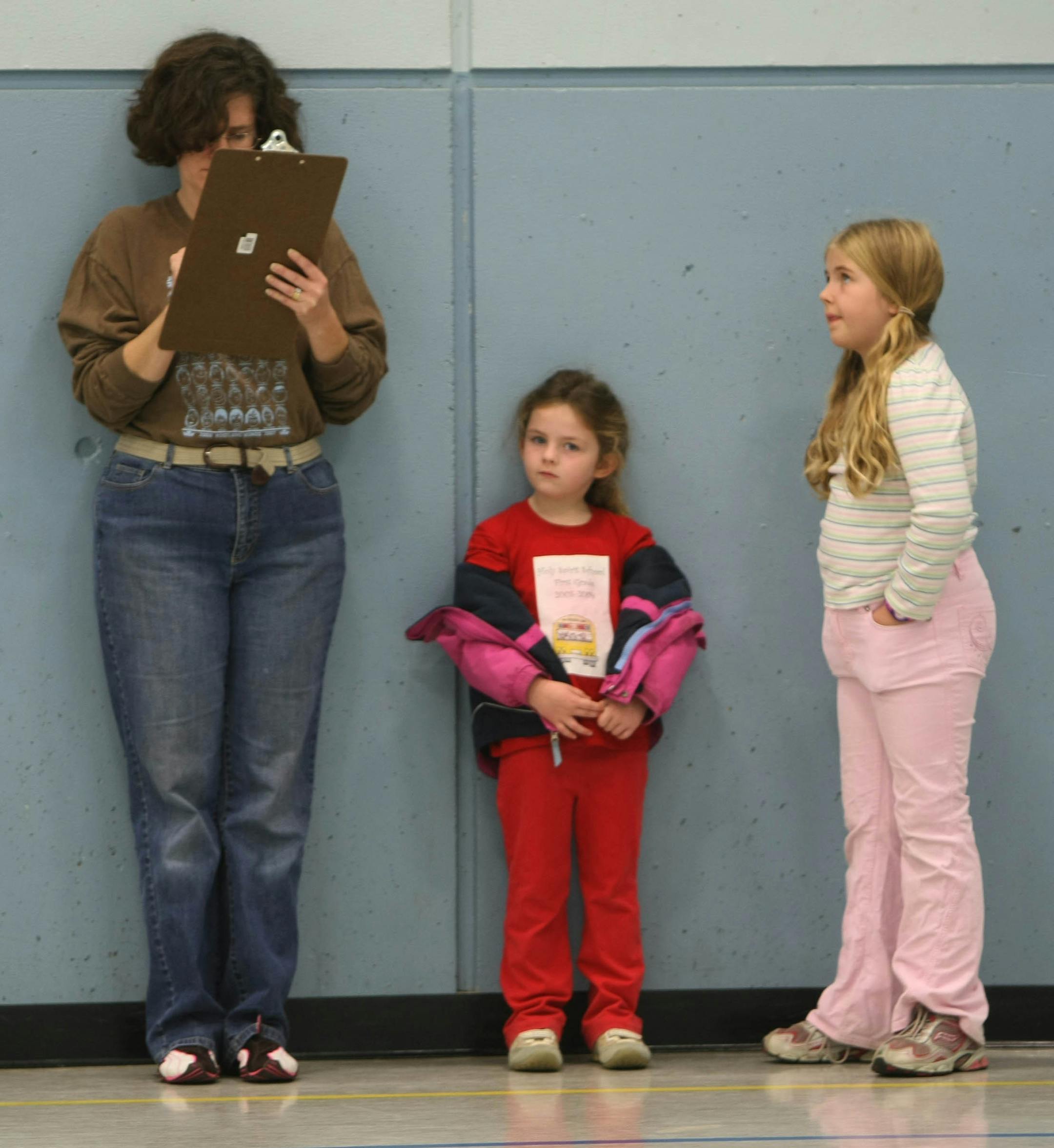 Joan Kenny of St. Paul voted as daughters Catherine, 6 and Mary, 8, waited.