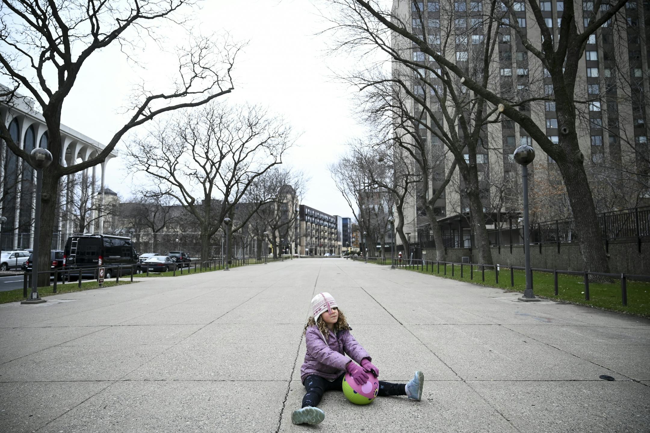 Rozlyn Gerber, 6, a kindergartener from downtown Minneapolis, played with a ball by her lonesome on South Second Street during what would normally be a busy Friday afternoon commute in the area. Her mother was standing nearby and wanted to get outside to get some fresh air.