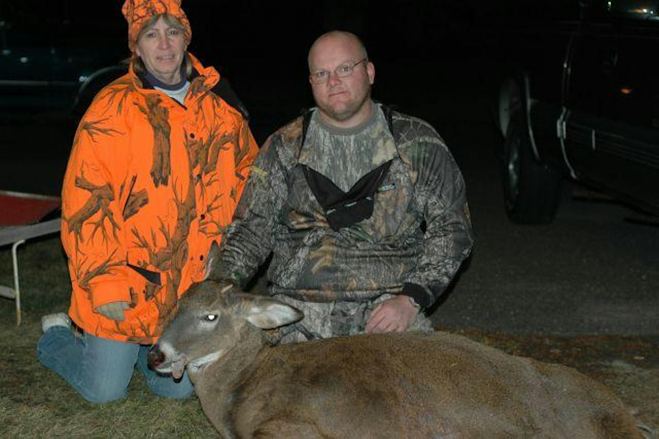 Barb and Charles Kannegaard look over an odd spike buck.