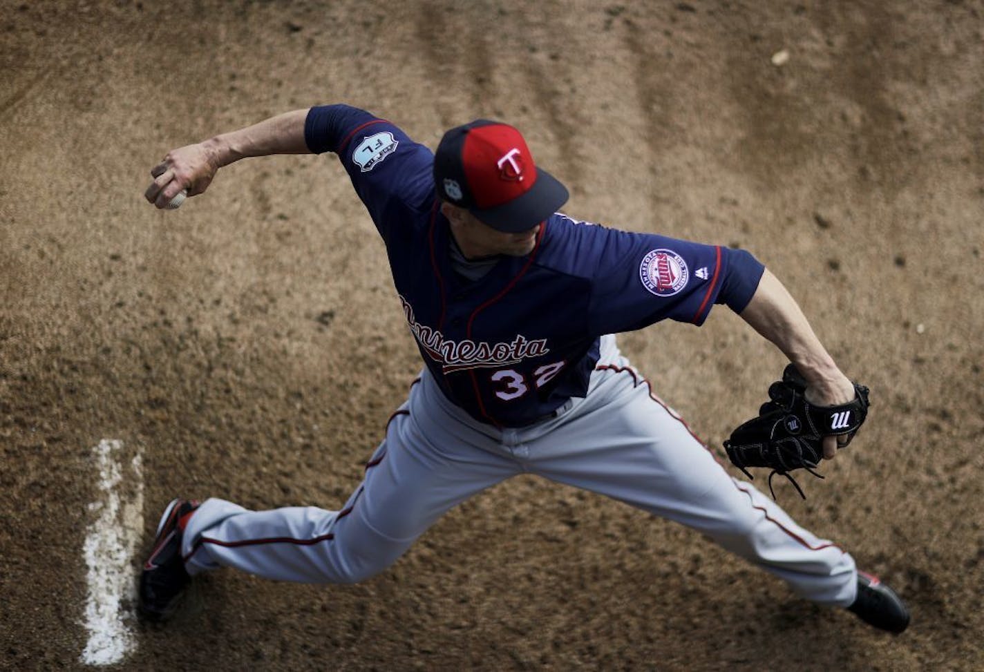 Minnesota Twins pitcher Ryan Vogelsong winds up to throw in the bullpen during a baseball spring training workout in Fort Myers, Fla., Thursday, Feb. 16, 2017.