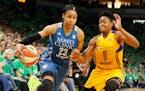 Maya Moore, left, drives around Los Angeles Sparks' Alana Beard in the second half during Game 5 of the 2016 WNBA Finals