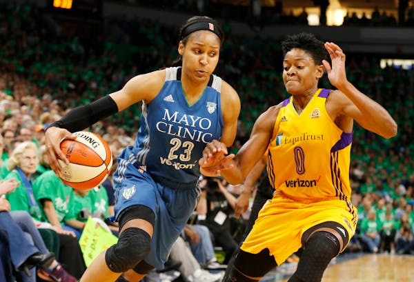 Maya Moore, left, drives around Los Angeles Sparks' Alana Beard in the second half during Game 5 of the 2016 WNBA Finals