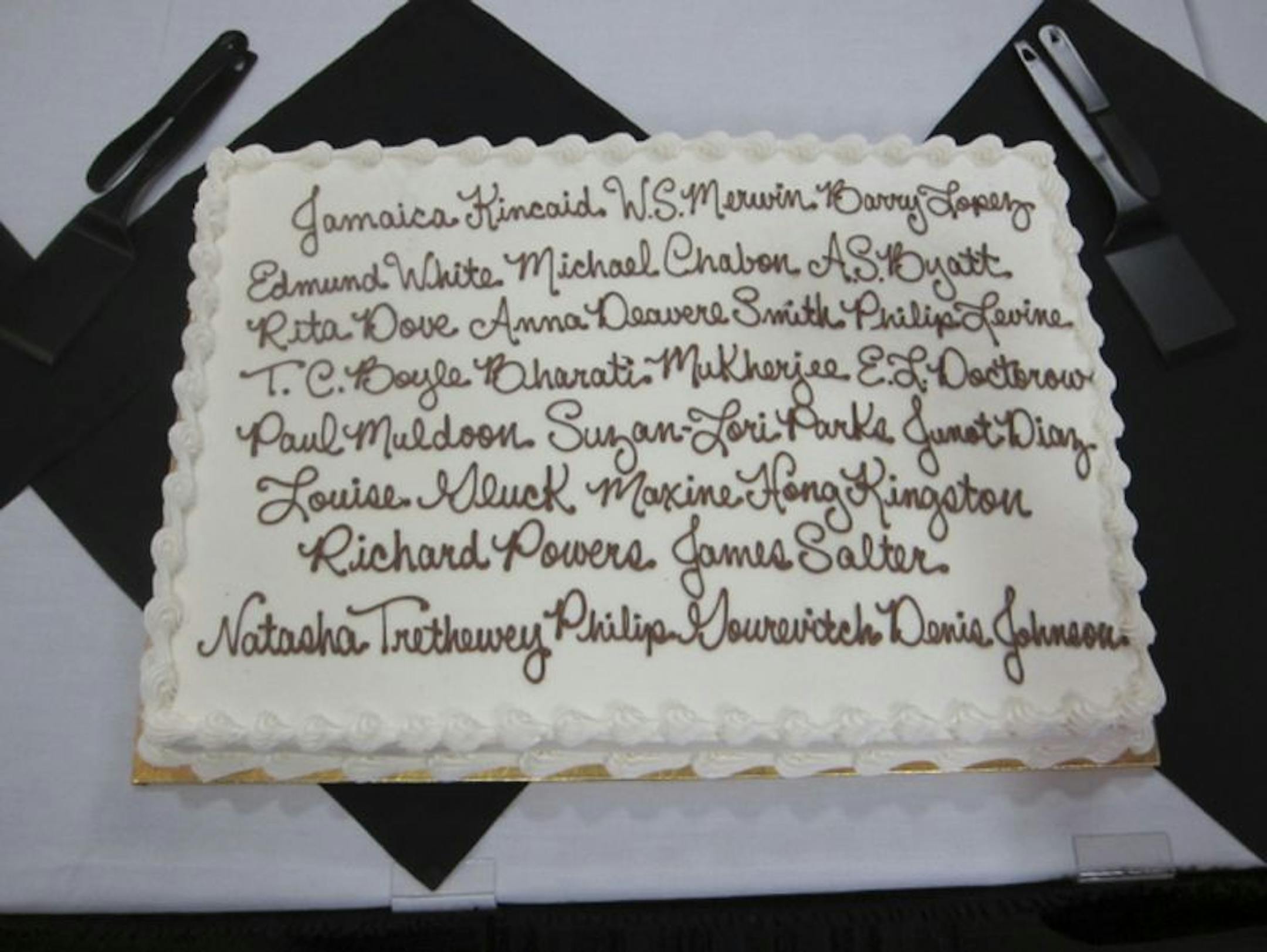 A cake decorated with the names of authors who've been brought in for the Esther Freier Endowed Lecture in Literature.