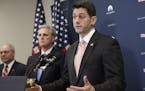 House Speaker Paul Ryan of Wis., right, gave a strong defense of President Donald Trump's refugee and immigration ban to caucus members and said he ba