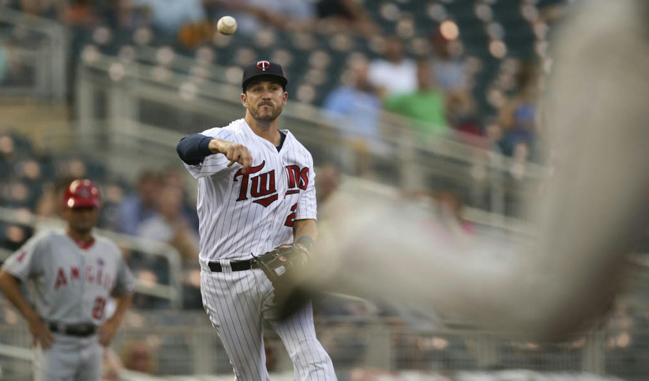 Twins' third baseman Trevor Plouffe threw to first to nab the Angels' Tommy Field in the third inning.