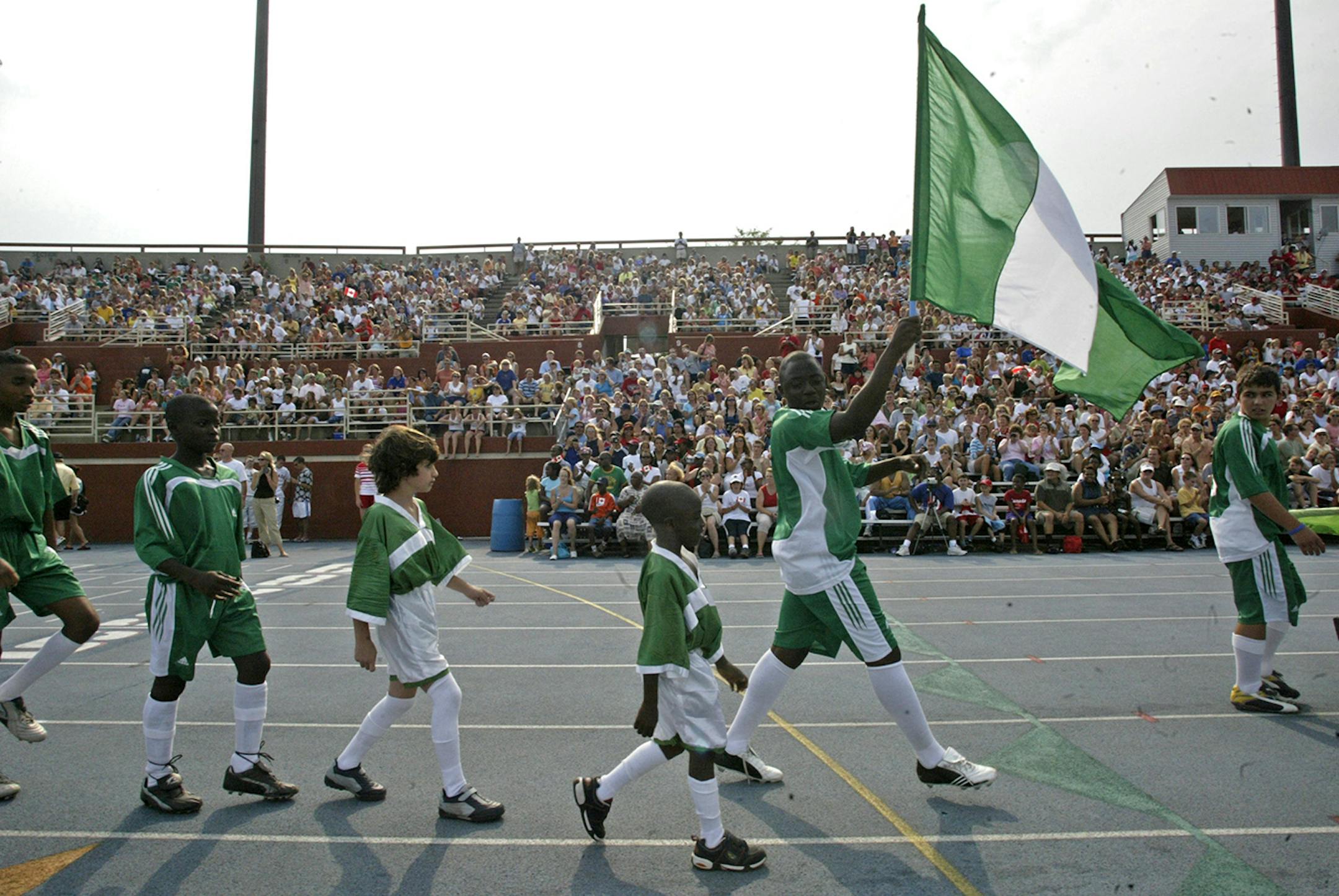 Marlin Levison - Strib 07/17/05 - Assign#97521- The Schwan's USA Soccer Cup event got under way Sunday afternoon at National Sports Center in Blaine with opening ceremonies and a parade of the 982 soccer teams from around the world. There was plenty of enthusiasm with the players as they lined up for their walk into the stadium and applause by several thousand spectators.
IN THIS PHOTO: Teams from Nigeria enter the stadium.
