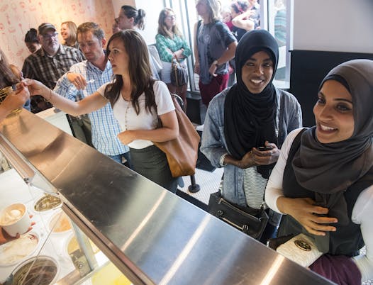 From left, Jon and Sara O' Brien sample ice cream flavors as Salma Hassan and Nancy Mahdy waited for their ice cream orders at Milkjam.
