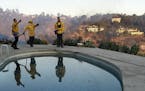 From left, Florin Sarbu, Dan Smithers, and Robert Caropino of the Los Angeles City Fire Dept. monitor the Skirball fire, from the backyard of a home o