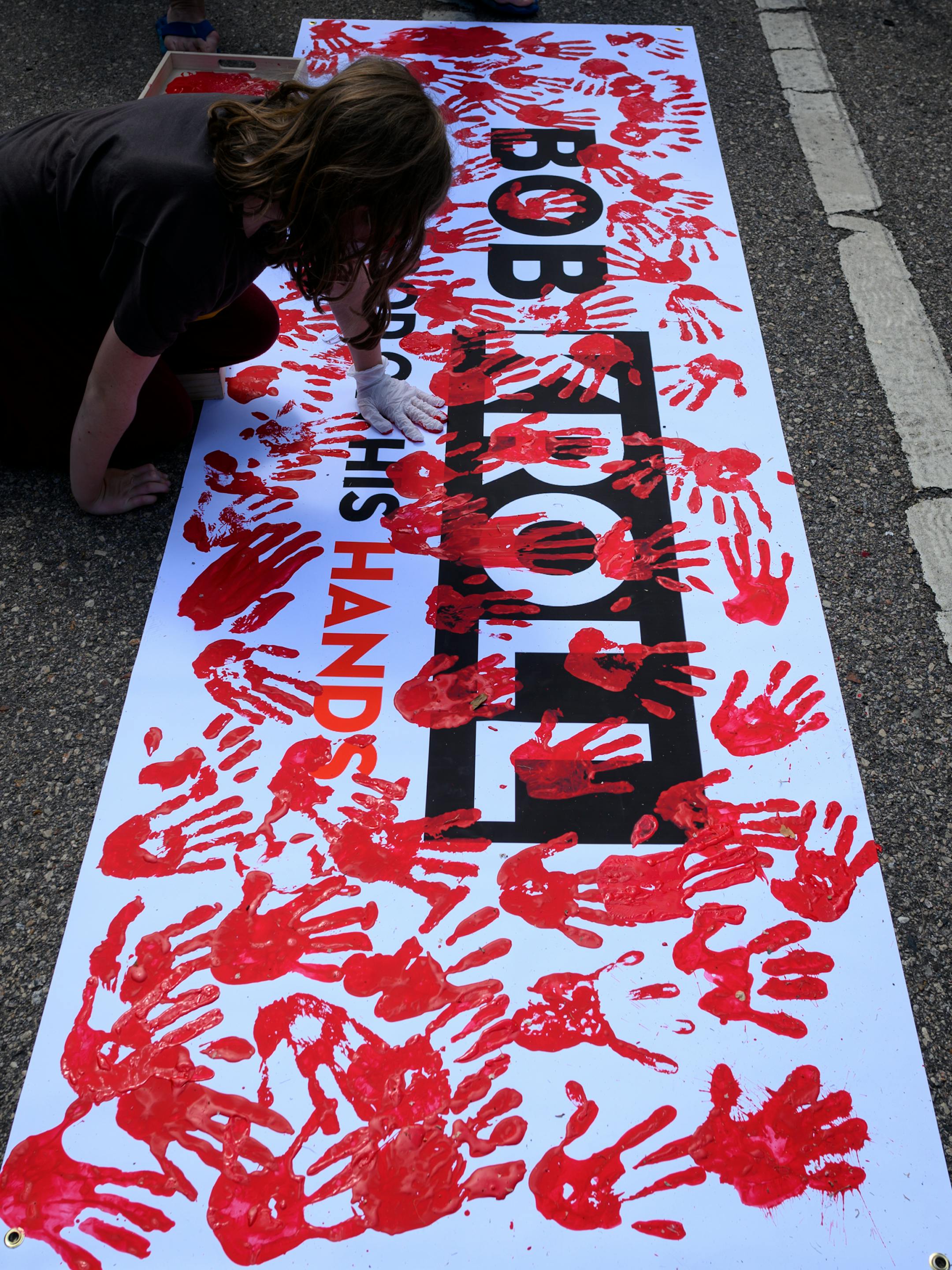 Protesters painted an anti-Bob Kroll sign with red handprints, representing blood. ]
aaron.lavinsky@startribune.com Protesters took part in a "Bob KKKroll Must Go!" rally against the Minneapolis Police Union and its president outside the union headquarters on Friday, June 12, 2020 in MInneapolis, Minn.