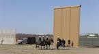 Border Patrol on horses stop by while testing is underway of a border wall prototype on Dec. 1, 2017 in Tijuana, Mexico. (Alejandro Tamayo/San Diego U