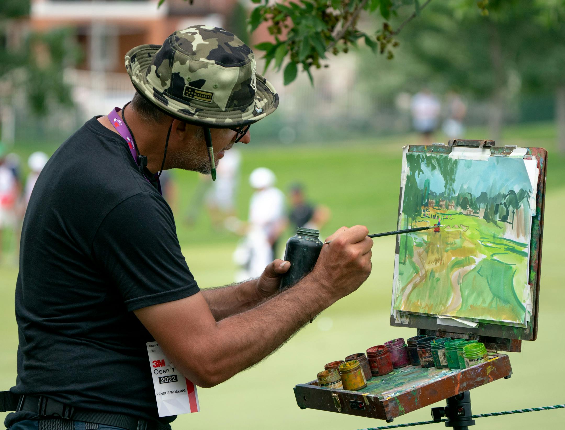 Artist Kickliy paints the eighth hole during the 3M Open.