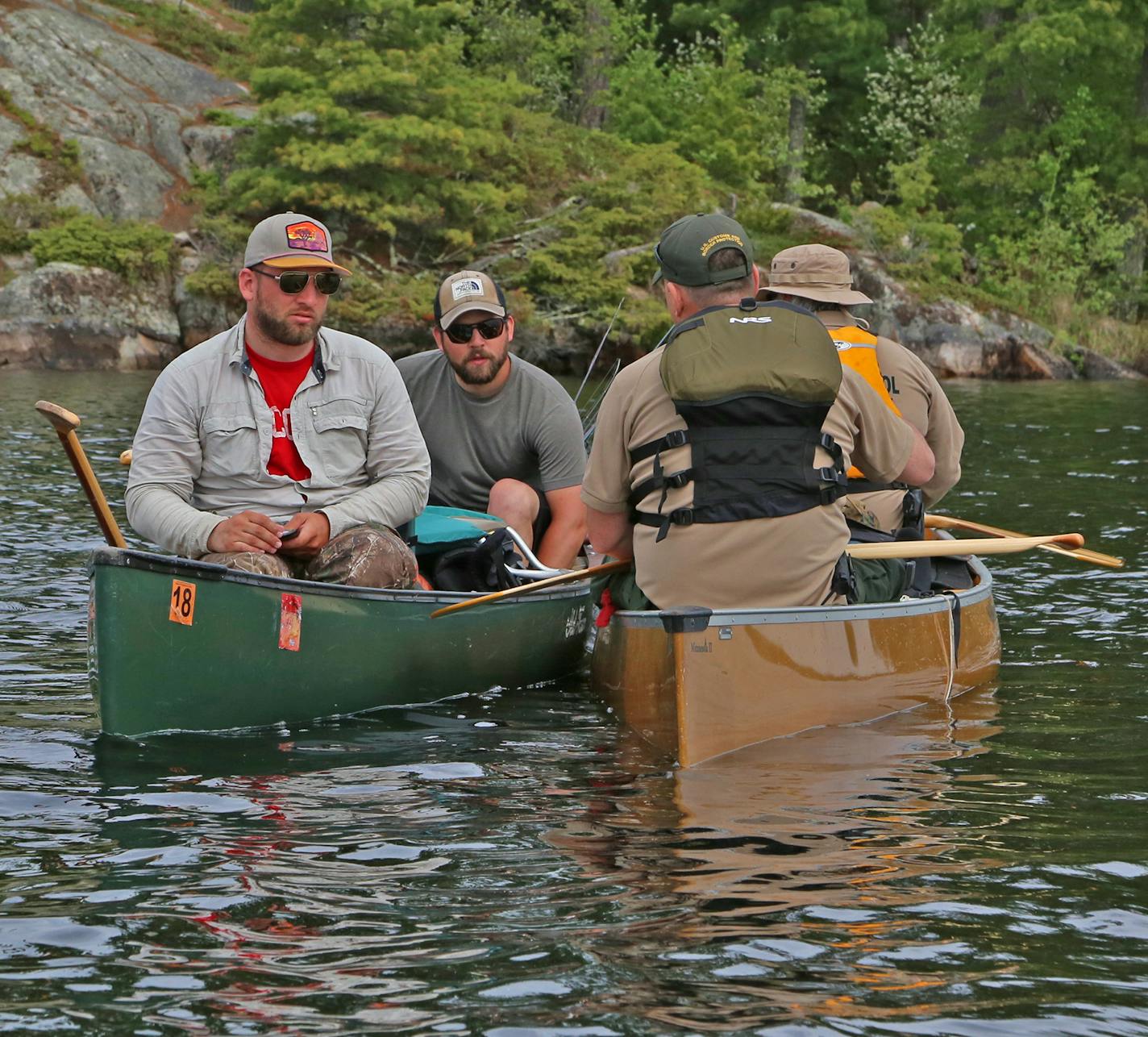 Jorge Gomez (in bow of canoe) and Matt Curran talked to paddlers in a routine stop. The paddlers checked out and were soon on their way.