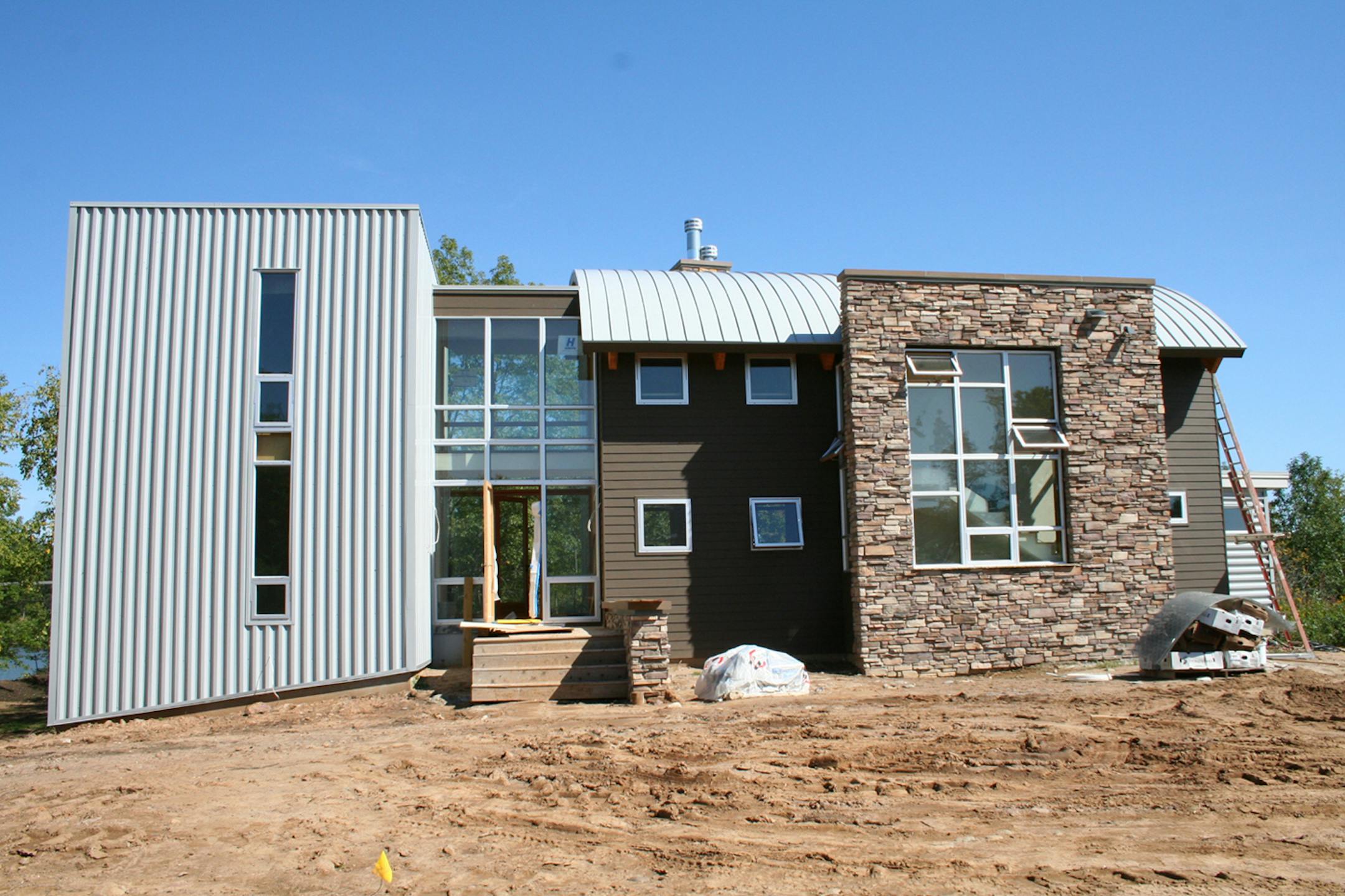 A brick-and-metal exterior frames John and Debra Beard's Baldwin, Wis., home. The barrel roof softens the industrial metal and ties the structure to the surrounding rolling hills.