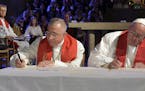 Pope Francis, right, and the President of the Lutheran World Federation Bishop Munib Younan sign a joint declaration during an ecumenical prayer in th