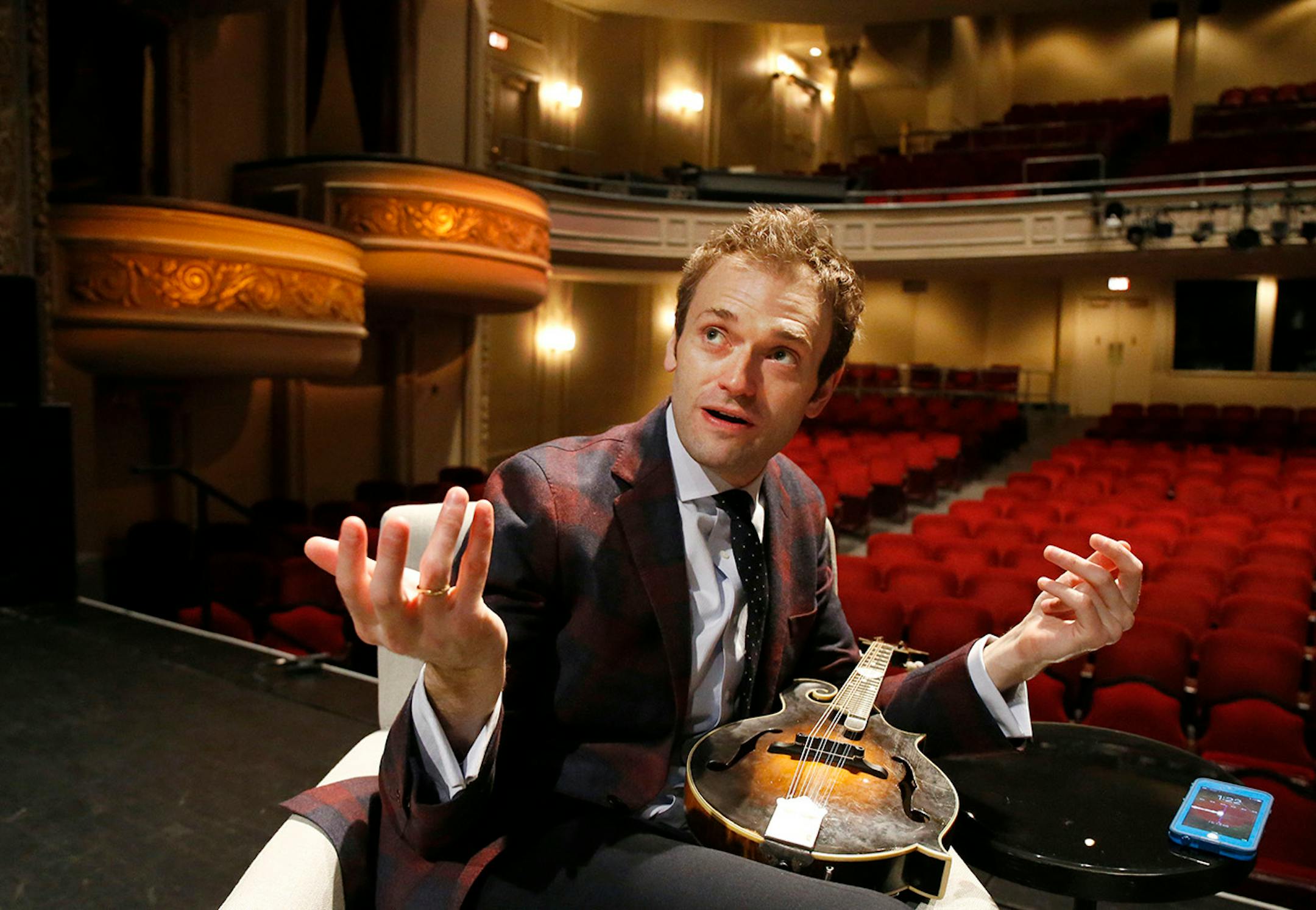 In this April 5, 2016 photo, Chris Thile gestures during an interview at the Fitzgerald Theater in St. Paul, Minn. Thile will replace Garrison Keillor as host of "A Prairie Home Companion," the popular public radio variety show, after Keillor retires this summer. Thile starts hosting a 13-episode run of the show in October.