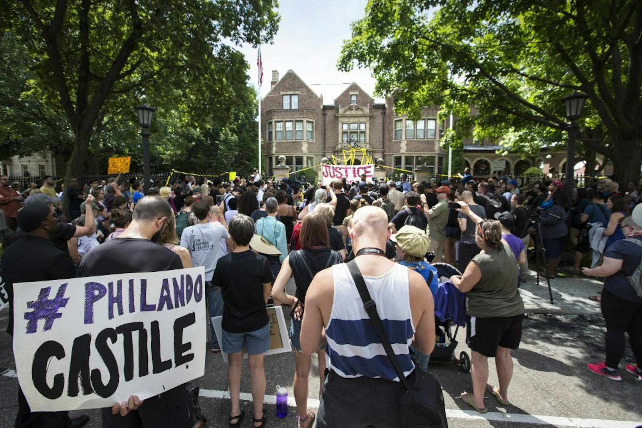 Protesters gather for speeches outside the governor's residence regarding the death of Philando Castile, 32, who was killed by police during a traffic stop in Falcon Heights, Minn., on Wednesday, July 6, 2016.