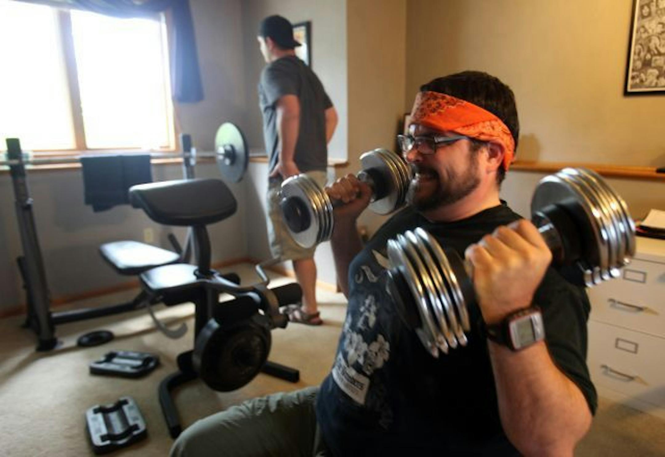 Jed Wannarka went through his weightlifting regimen with his friend Brandon Henderson which started after he was laid off.