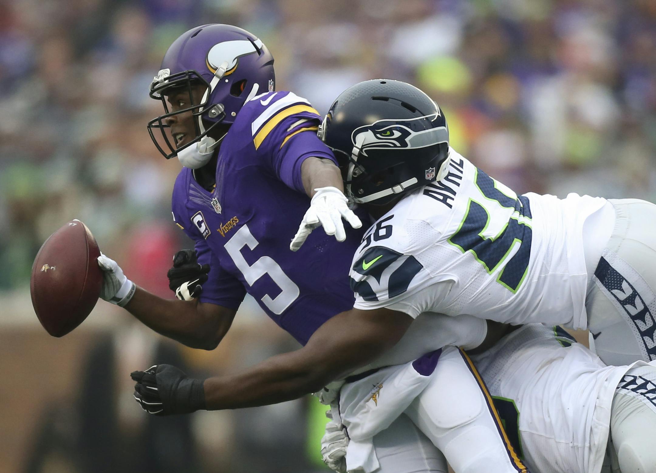 Vikings quarterback Teddy Bridgewater (5) was sacked for a five yard loss in the first quarter Sunday by Seahawks defensive ends Frank Clark (55) and Cliff Avril (56). ] JEFF WHEELER ï jeff.wheeler@startribune.com The Minnesota Vikings faced the Seattle Seahawks in an NFL football game Sunday afternoon, December 6, 2015 at TCF Bank Stadium in Minneapolis.