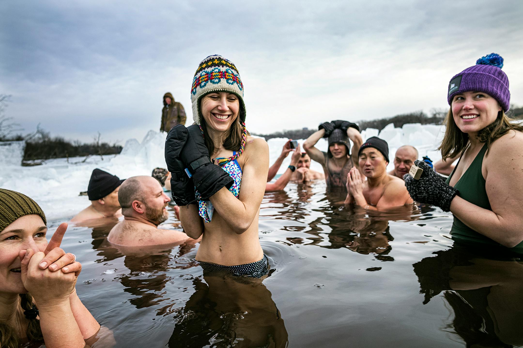 Svetlana Vold, left, and Sadie Mae enjoy the balmy 34 degree water in Cedar Lake in Minneapolis.