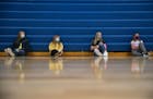 (From left) Harper Carlson, Addison Erickson, Jaycee McMillan and Carley Lawry, all seventh grade students, listened to their teacher during gym class