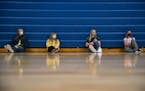 (From left) Harper Carlson, Addison Erickson, Jaycee McMillan and Carley Lawry, all seventh grade students, listened to their teacher during gym class