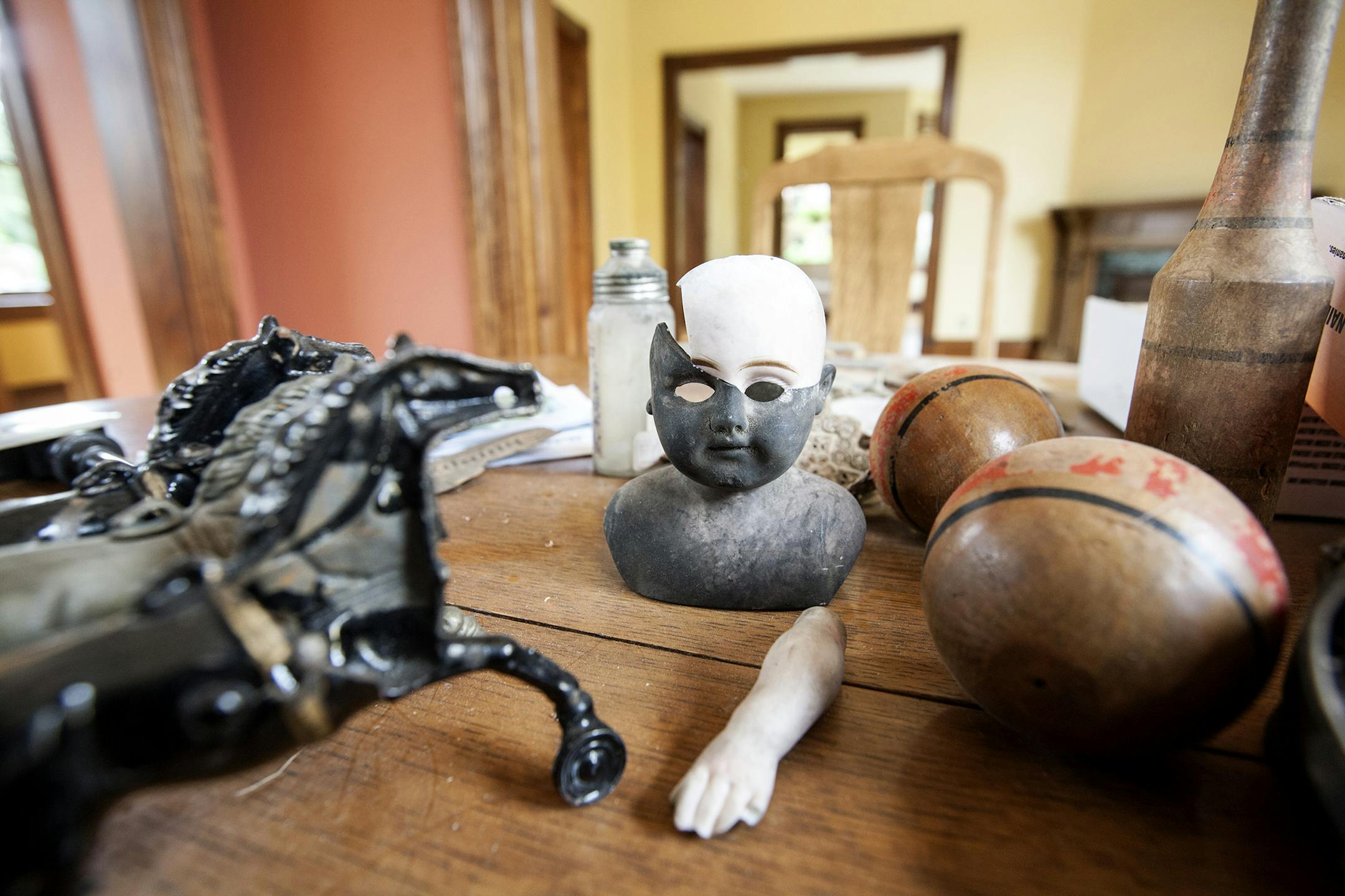 Robert Hengelfelt found numerous toys, pamphlets, and clothing items under the floorboards of the 1880's Victorian home that his company, Hengelfelt Restoration, rehabilitated in St. Paul August 20, 2014. (Courtney Perry/Special to the Star Tribune)
