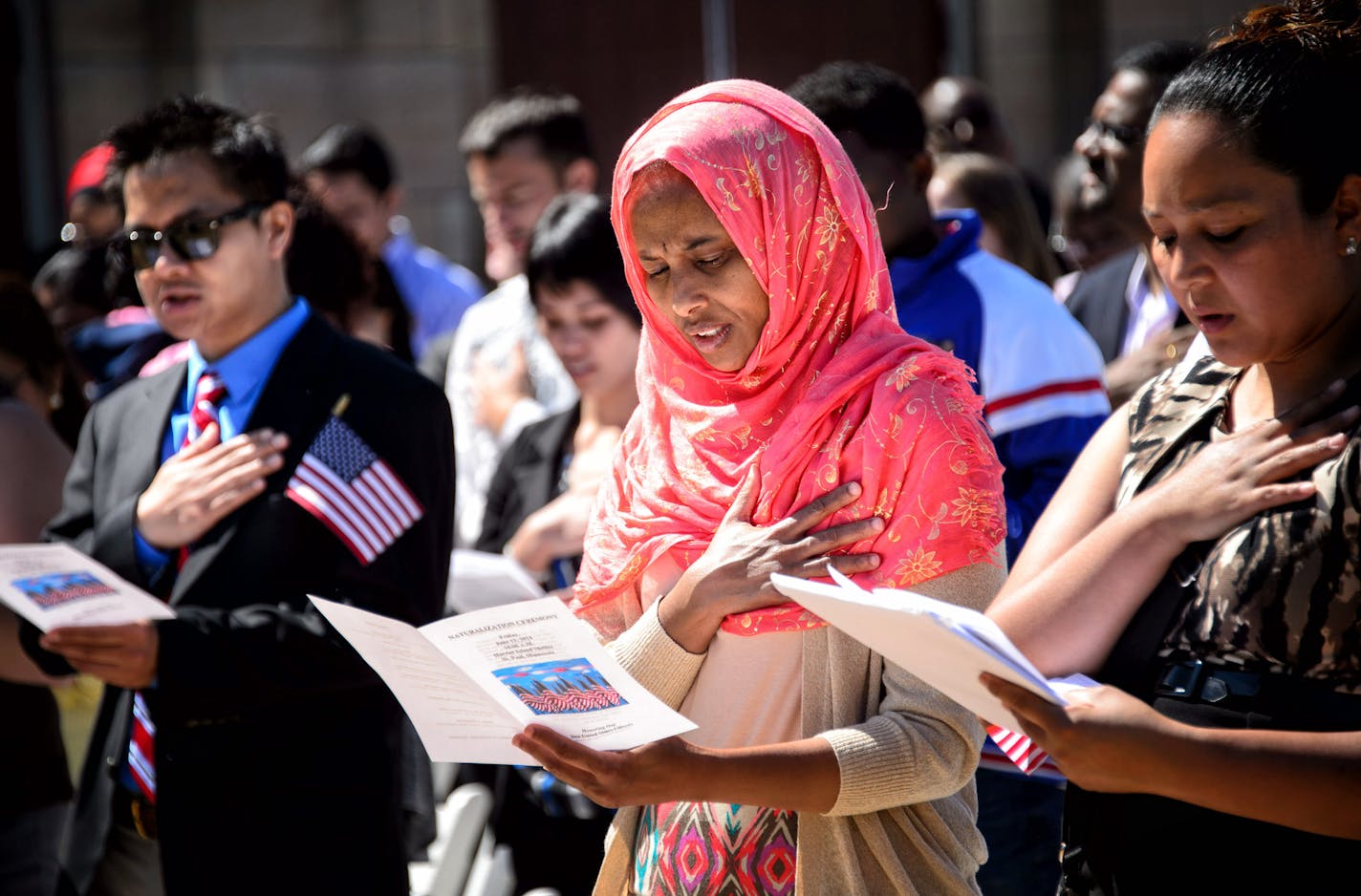 New citizen Zamzam Gulled from Somalia recited the Pledge of Allegiance during the ceremony. 135 immigrants were sworn in as U.S. citizens today, Friday June 13, 2014, at the Harriet Island Pavilion overlooking the banks of the Mississippi River. ] GLEN STUBBE * gstubbe@startribune.com