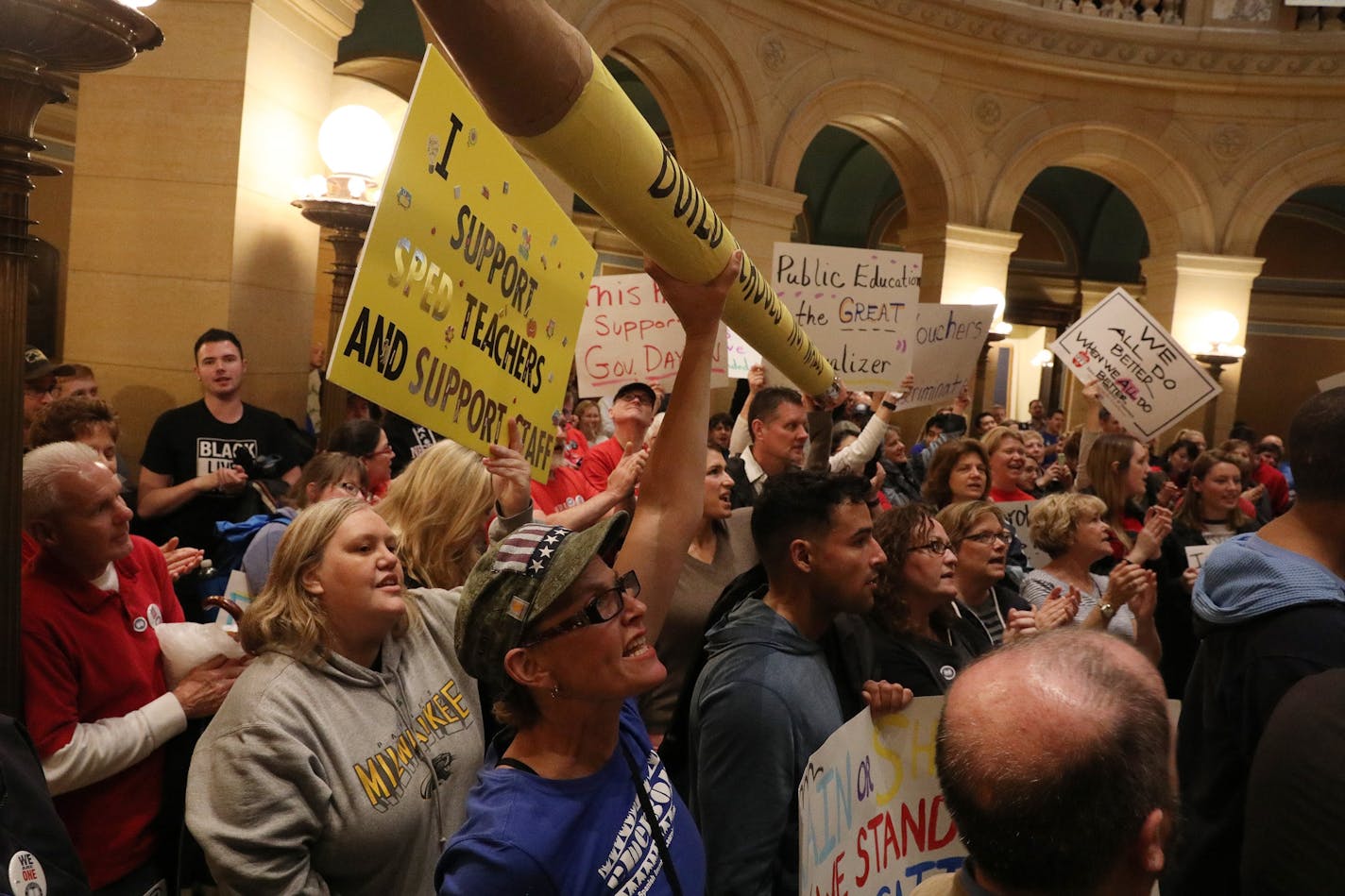 Protesters brought an oversized pencil to make their point during a rally against cuts to public education Saturday.