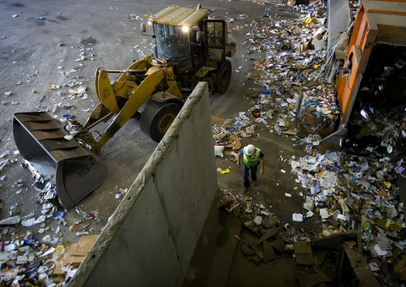 Jerrell Stewart (left) and Martin Kellers (right) work the sort line at Dem-Con recycling facility in Shakopee. ] Global economic trends are putting a squeeze on the big blue bin. Metro area cities accustomed to earning money from the processing of recyclables are suddenly having to pay -- a consequence of rock bottom oil prices and a slowing Chinese economy. The tumbling price for plastics and other materials is taking a toll on the local and recycling market. If trends don't improve, recycling