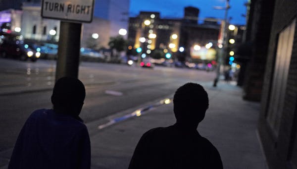 In downtown, a Minneapolis On July 1, 2014, a group of teenagers Antwon Seamon and JoJo Knight, left to right, claimed to be 13 or older were wanderin