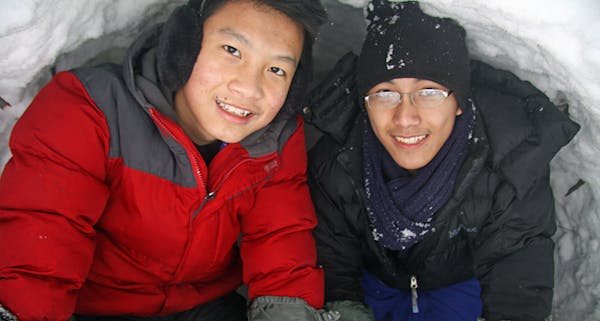Xeng Lee, left, and George Vang spent the night resting comfortably in a quinzee of their own design.