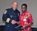 Plymouth Public Safety Director Mike Goldstein gives 17-year-old Urias Jah a Citizens Award on March 3. City officials commended the teen for his extr