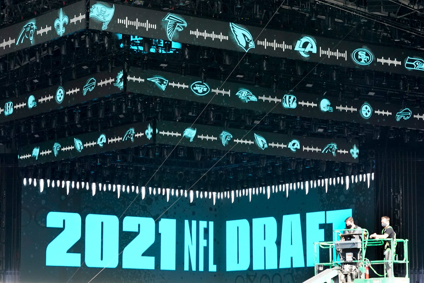 Workers continue preparing the NFL Draft Theatre for the 2021 NFL Draft, Tuesday, April 27, 2021, in Cleveland. After going all virtual in 2020 due to the COVID-19 pandemic, the three-day draft, which has grown into one of America's biggest, non-game sporting events, returns with thousands of fans who will be separated by their loyalties, and whether they've been vaccinated. (AP Photo/Tony Dejak)