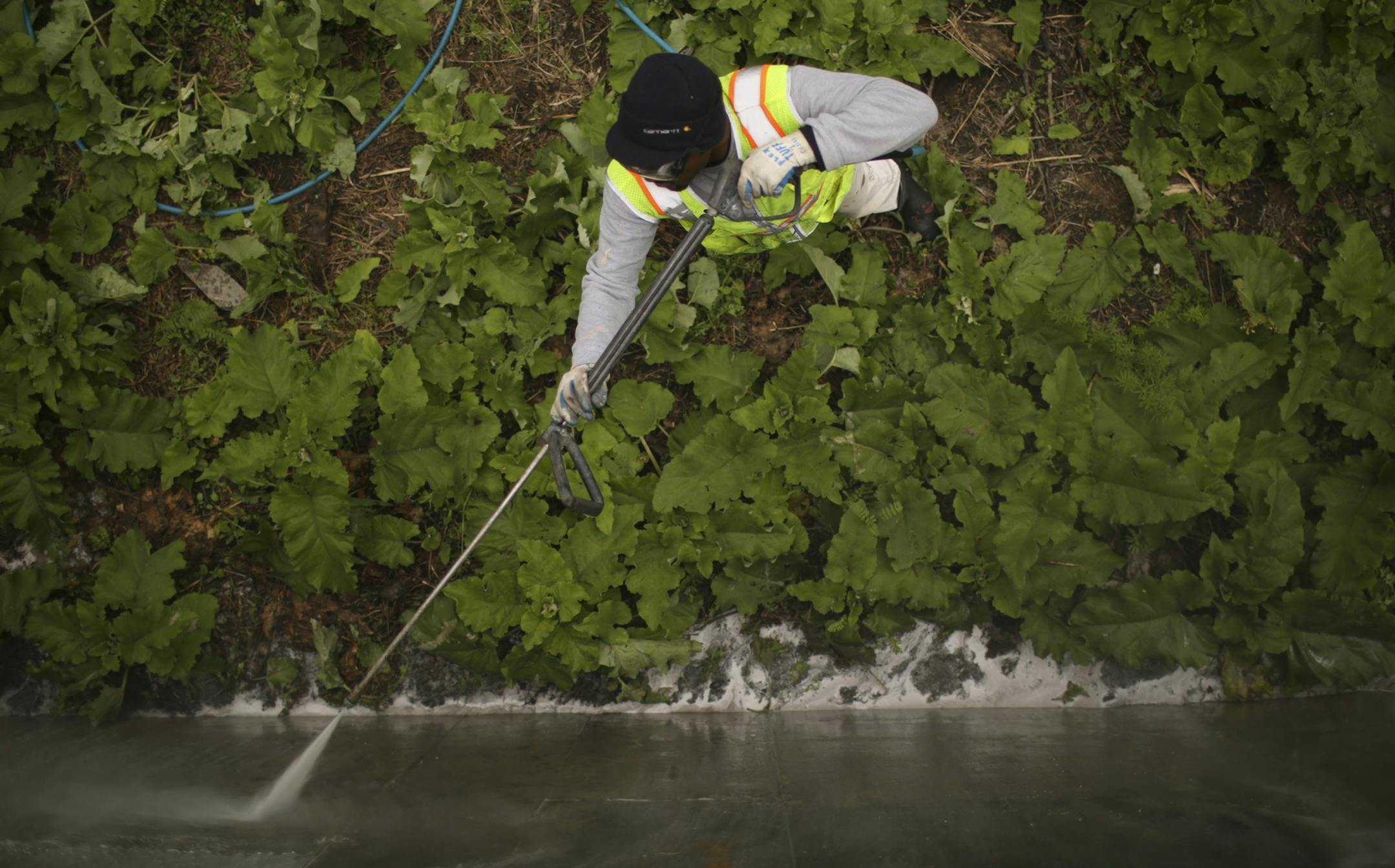After applying a powerful solvent, Robert power-washed a graffiti tag. &#x201c;I don&#x2019;t have slow days at all,&#x201d; he said of his 2,000 to 3,000 cleanups per year.
