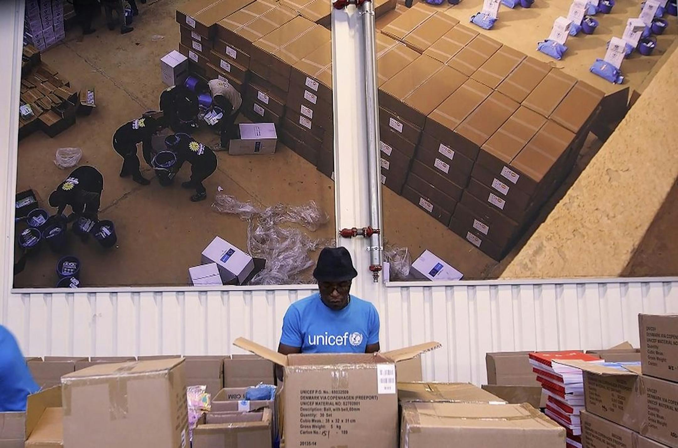 FILE - In this image taken from video on Tuesday Oct. 13, 2020, people work inside the UNICEF warehouse, the world's largest humanitarian aid warehouse, in Copenhagen, Denmark where the groundwork is being laid for the Covax initiative, led by the World Health Organization and the Gavi vaccine alliance. An IBM threat intelligence team said Thursday, Dec. 3 it detected a cyberespionage effort that used targeted phishing emails to try to collect sensitive information from organizations involved in