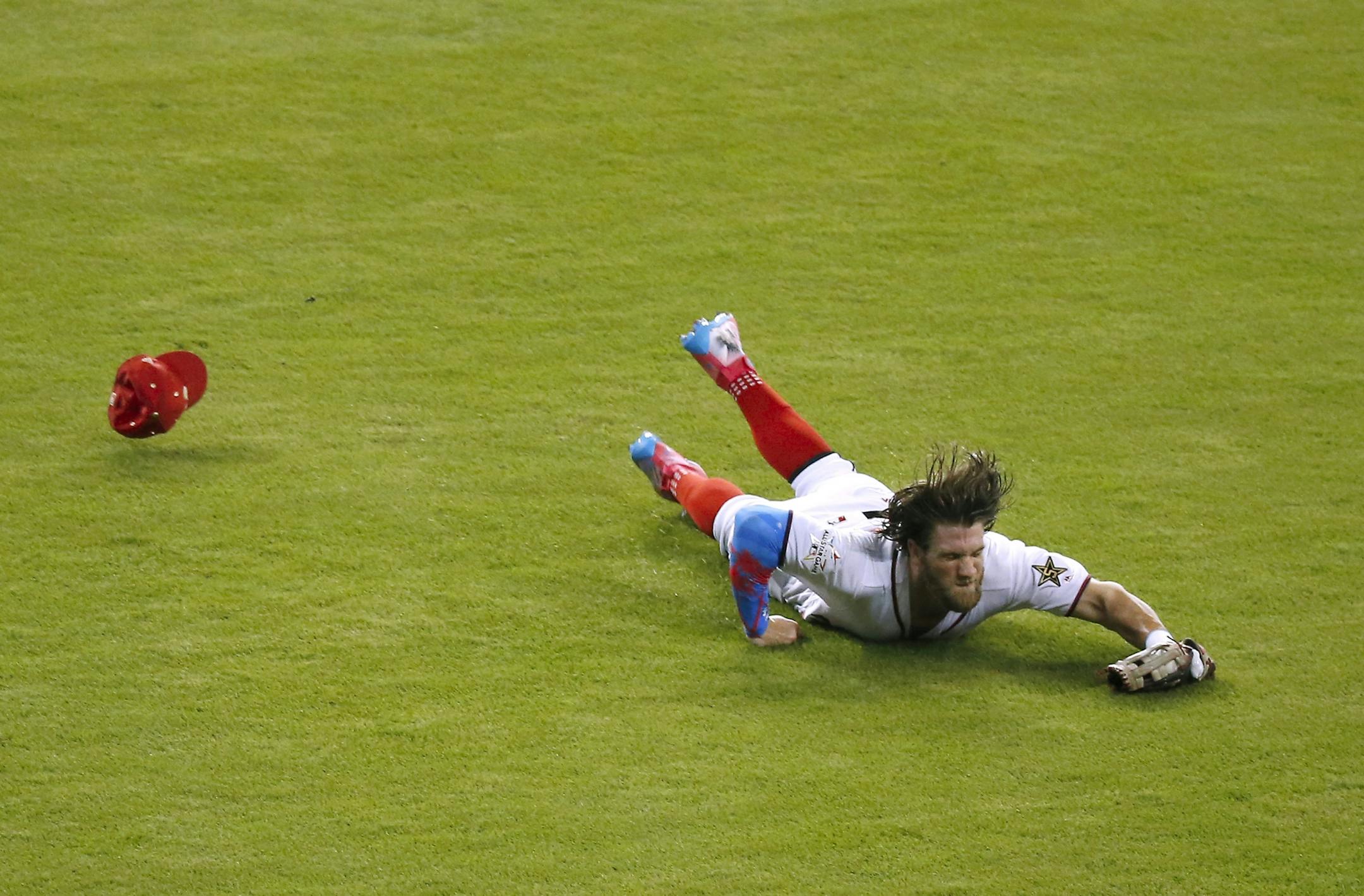 The National League's Bryce Harper of the Washington Nationals makes a catch on a fly ball by American League catcher Salvador Perez of the Kansas City Royals during the second inning of the MLB All-Star Game on Tuesday, July 11, 2017, at Marlins Park in Miami, Fla.
