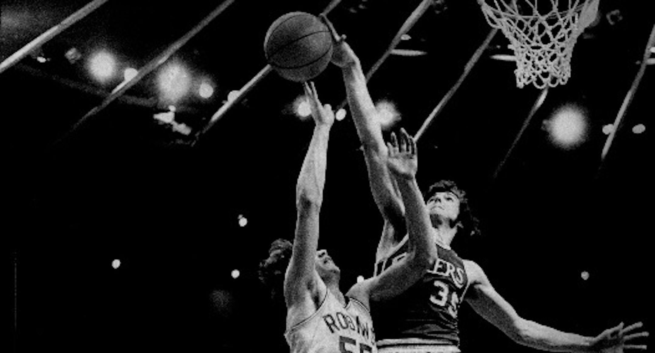 Little Falls center Frank Wachlarowicz, shown blocking a shot by Robbinsdale's Tom Fix in the 1975 Class AA title game, is one of 15 new Minnesota High School Basketball Hall of Famers.
