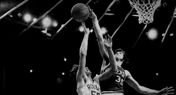 Little Falls center Frank Wachlarowicz, shown blocking a shot by Robbinsdale's Tom Fix in the 1975 Class AA title game, is one of 15 new Minnesota Hig