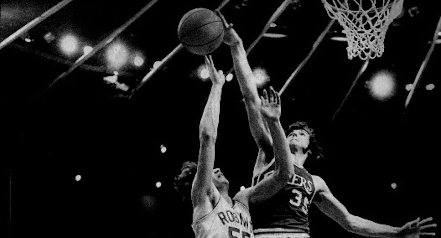 Little Falls center Frank Wachlarowicz, shown blocking a shot by Robbinsdale's Tom Fix in the 1975 Class AA title game, is one of 15 new Minnesota High School Basketball Hall of Famers.