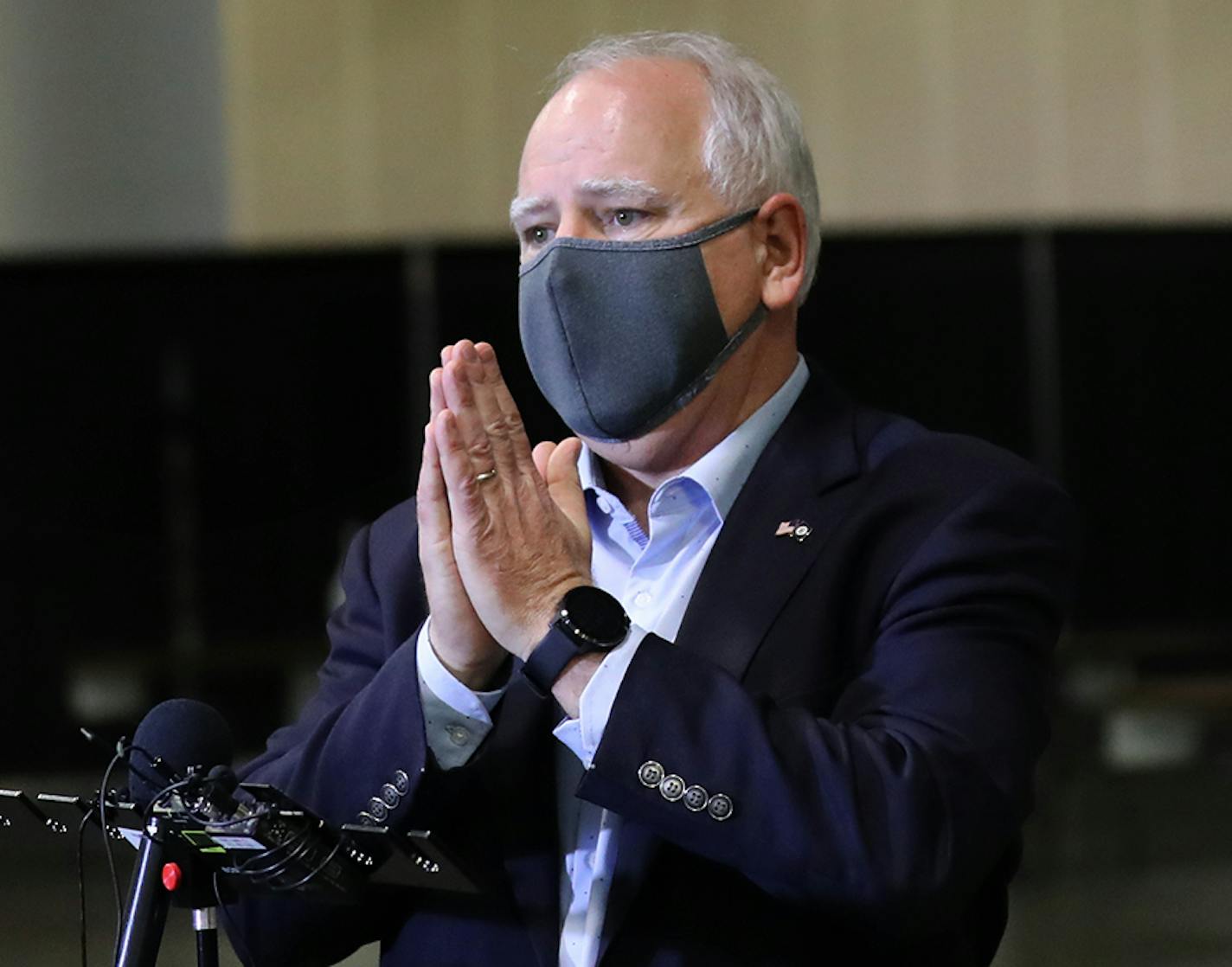 Gov. Tim Walz placed his hands together following a press conference at a new saliva testing center for COVID in the Minneapolis Convention Center that opened last week in Minneapolis.